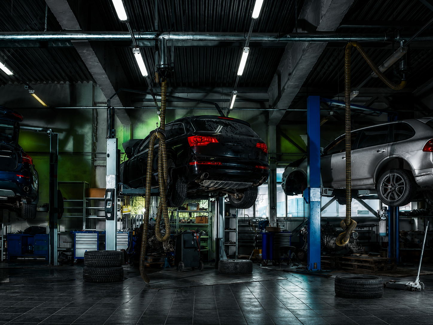 Vehicles on lifts inside a working diagnostic shop