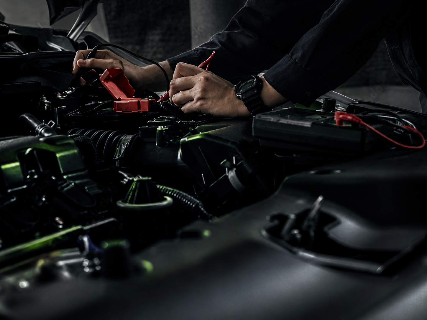 Technician using diagnostic leads on an engine